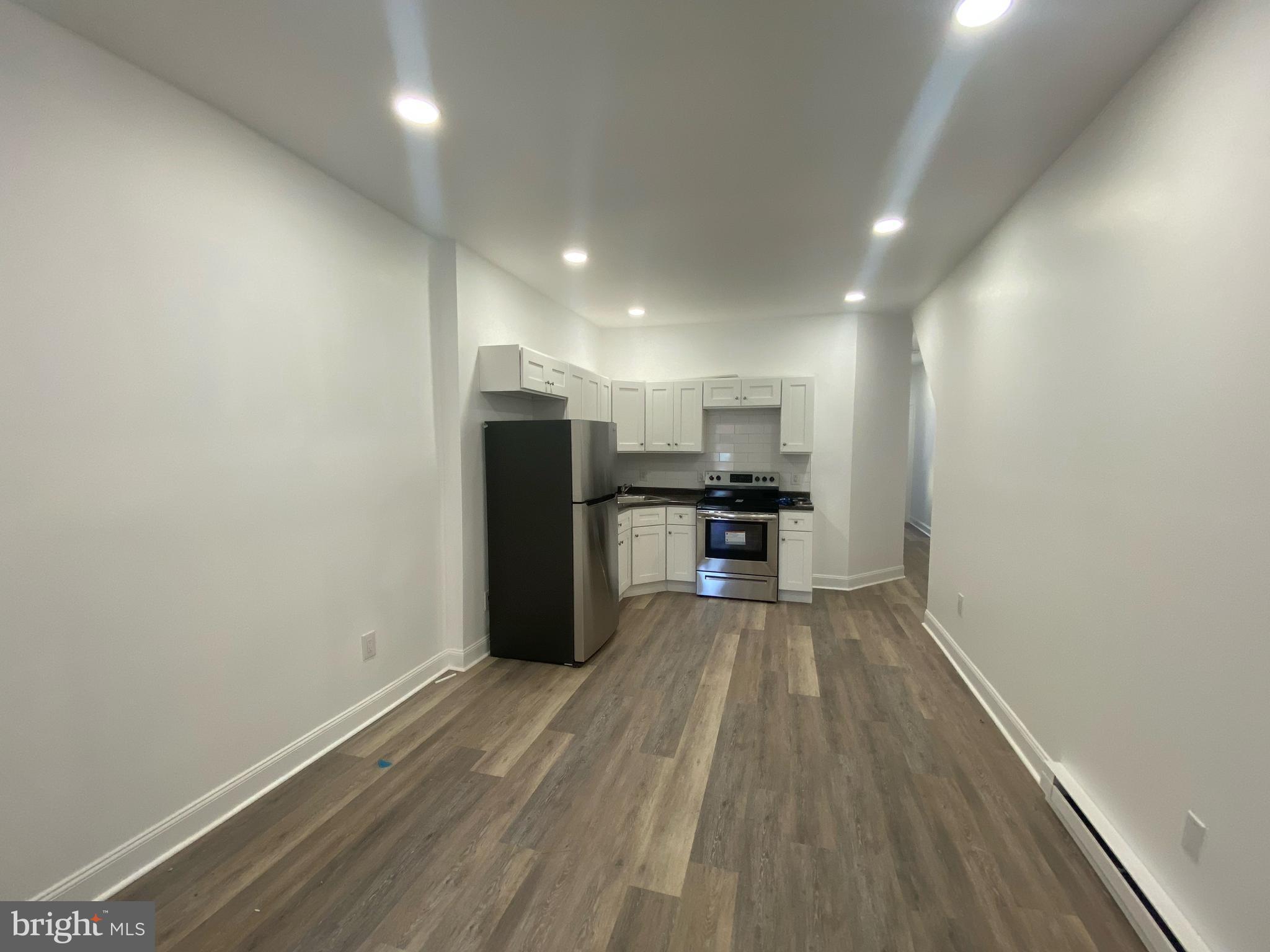 4019 Old York Road, Unit 1 Philadelphia, PA 19140 - Photo 1 of 5 a view of kitchen with wooden floor