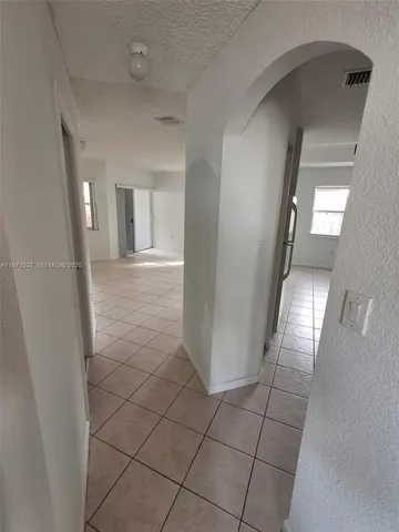 a kitchen with a sink a counter space and a stove top oven