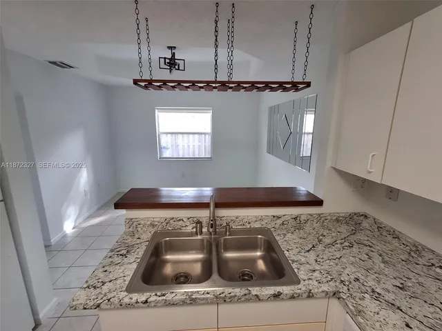 a bathroom with a sink vanity and mirror