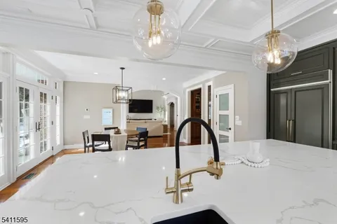 a large kitchen with kitchen island a dining table and chairs