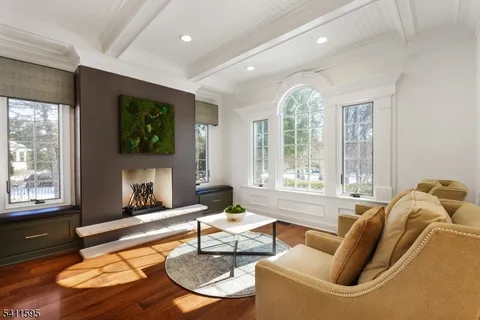 a living room with furniture fireplace and wooden floor