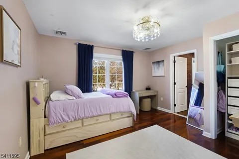 a bedroom with a bed and a desk