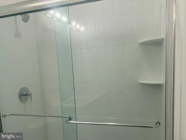 a bathroom with a glass shower door