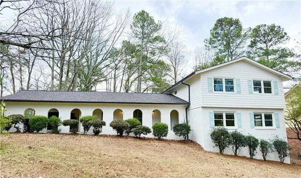a view of a house with wooden fence