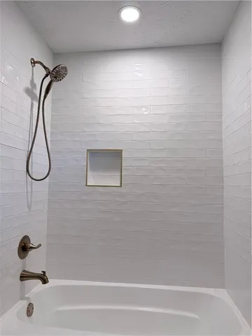 a bathroom with a shower and a bathtub