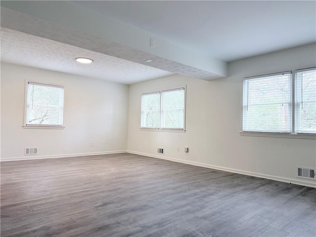 1863 Mt Vernon Road Dunwoody, GA 30338 - Photo 19 of 25 an empty room with wooden floor and windows