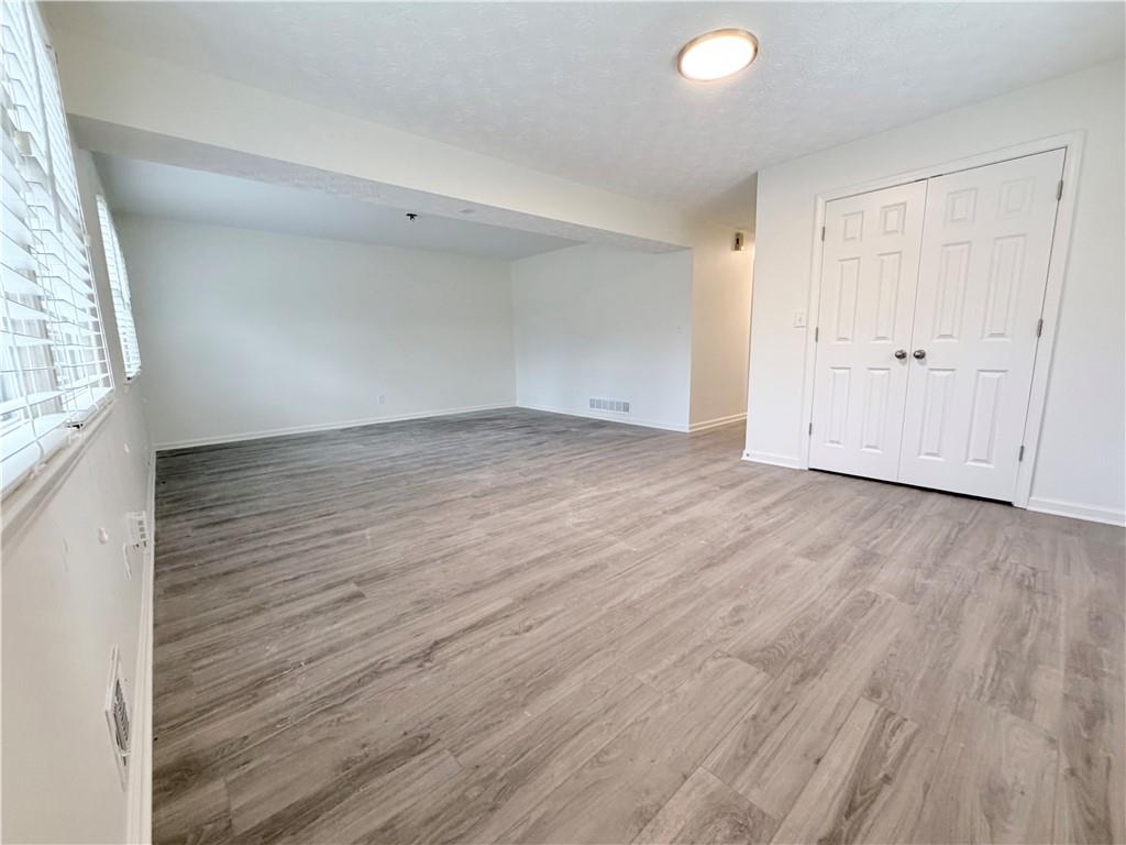1863 Mt Vernon Road Dunwoody, GA 30338 - Photo 20 of 25 an empty room with wooden floor and windows