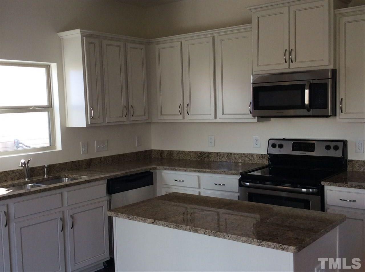 1441 Lombar Street Raleigh, NC 27610 - Photo 3 of 9 a kitchen with granite countertop a sink and a stove
