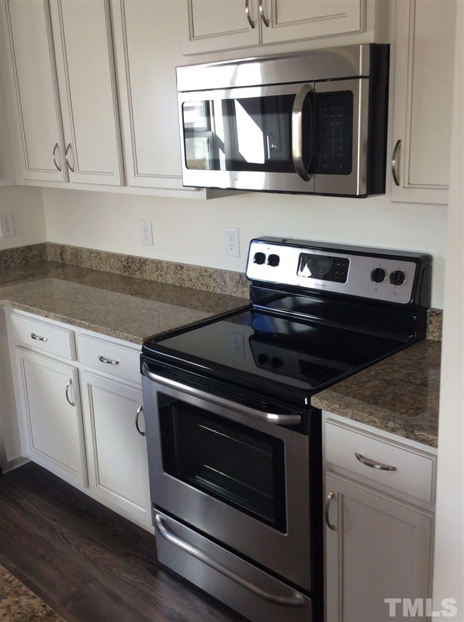 1441 Lombar Street Raleigh, NC 27610 - Photo 5 of 9 a stove top oven sitting inside of a kitchen