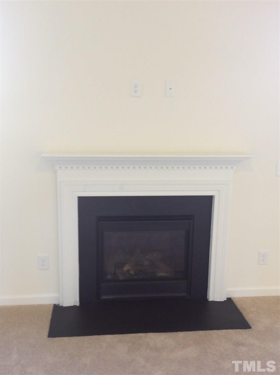 1441 Lombar Street Raleigh, NC 27610 - Photo 7 of 9 a living room with a fireplace