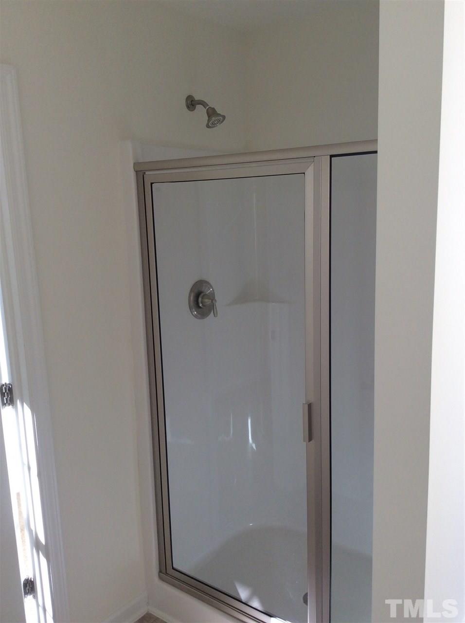 1441 Lombar Street Raleigh, NC 27610 - Photo 8 of 9 a bathroom with a glass shower door