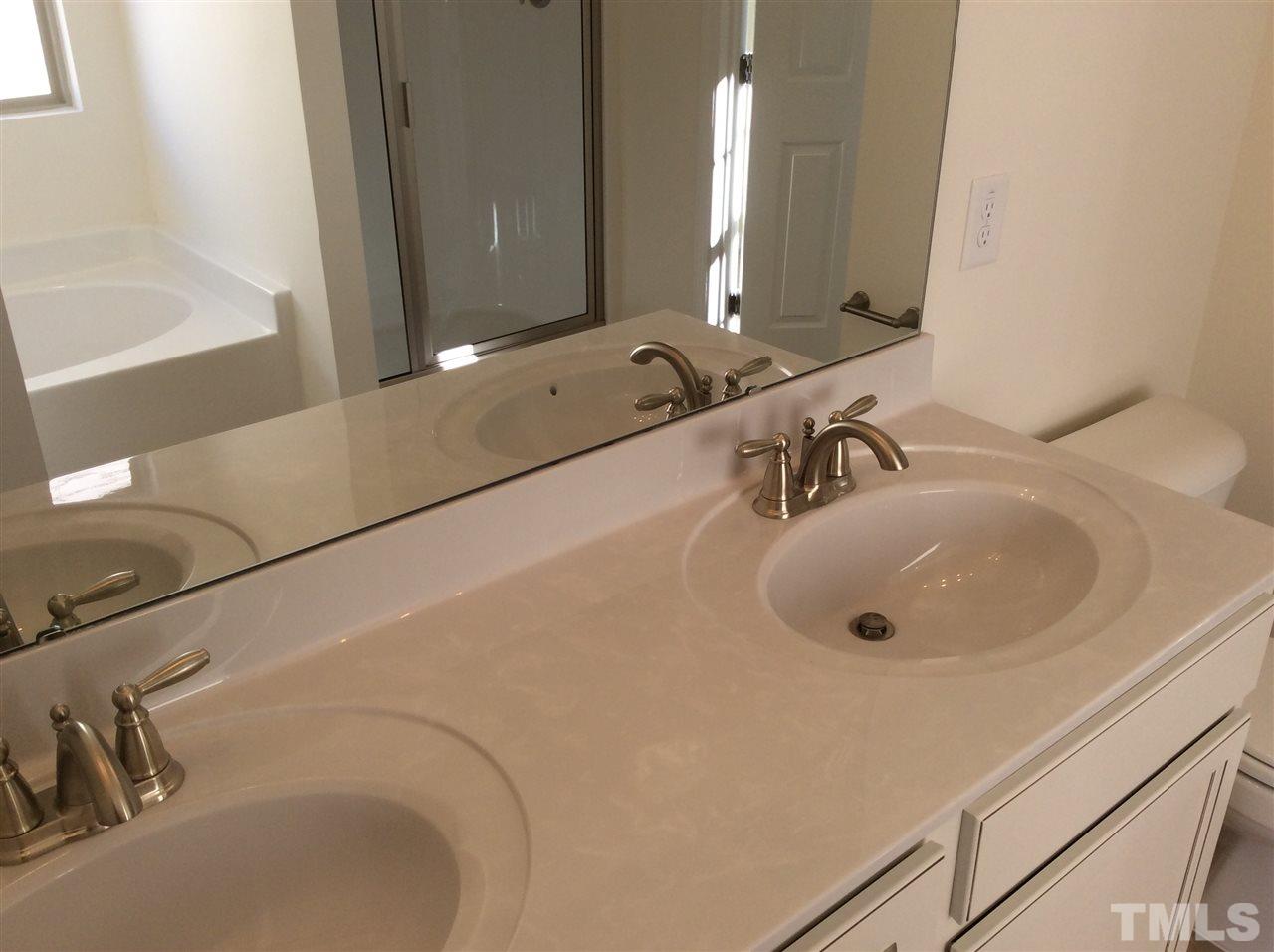 1441 Lombar Street Raleigh, NC 27610 - Photo 9 of 9 a bathroom with a sink and a mirror