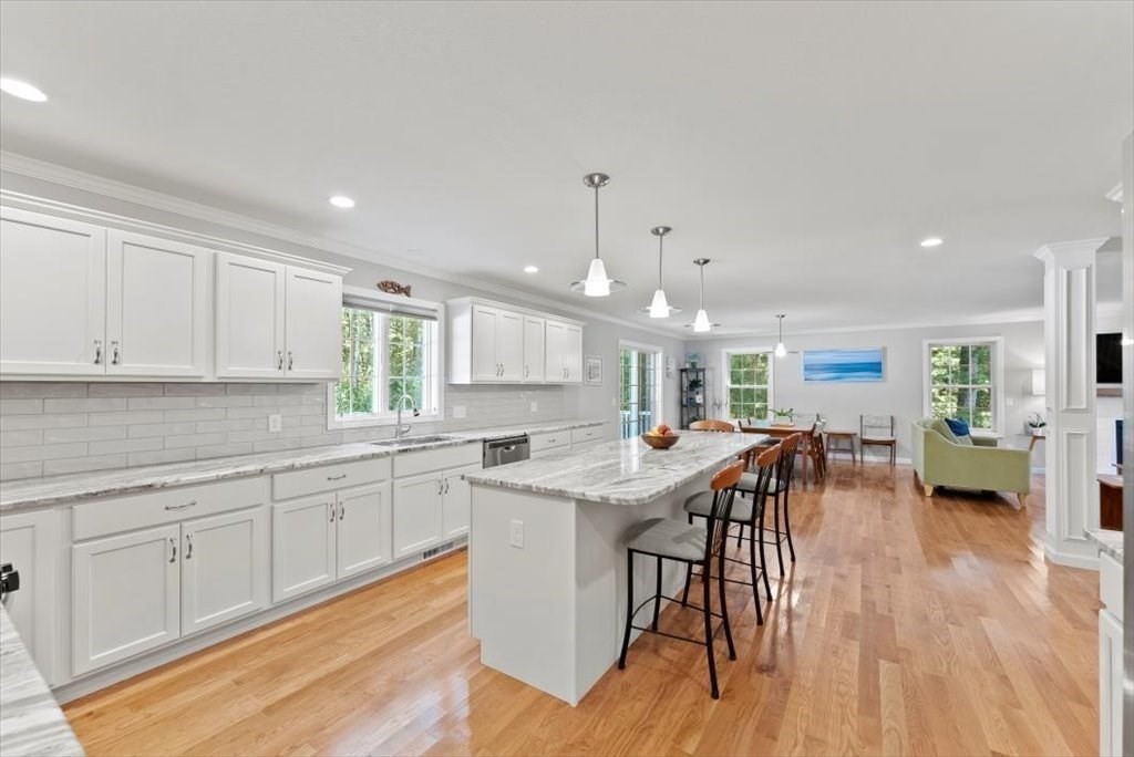 145 Barrington Drive Springfield, MA 01129 - Photo 17 of 42 a kitchen with stainless steel appliances granite countertop a table chairs sink and cabinets