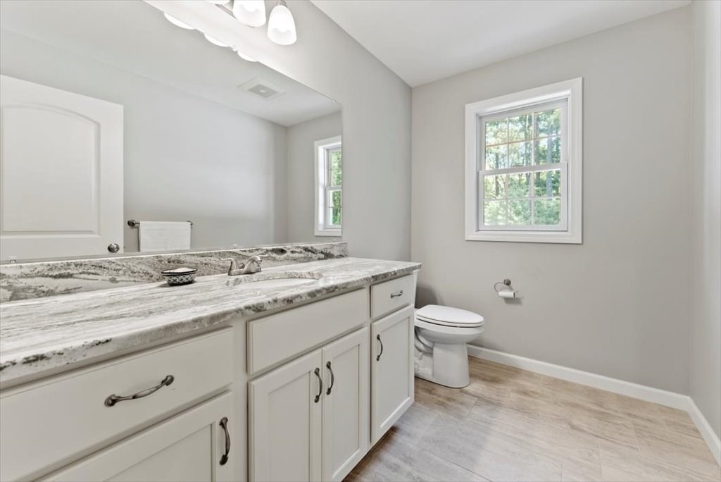 145 Barrington Drive Springfield, MA 01129 - Photo 21 of 42 a bathroom with a granite countertop toilet sink and mirror