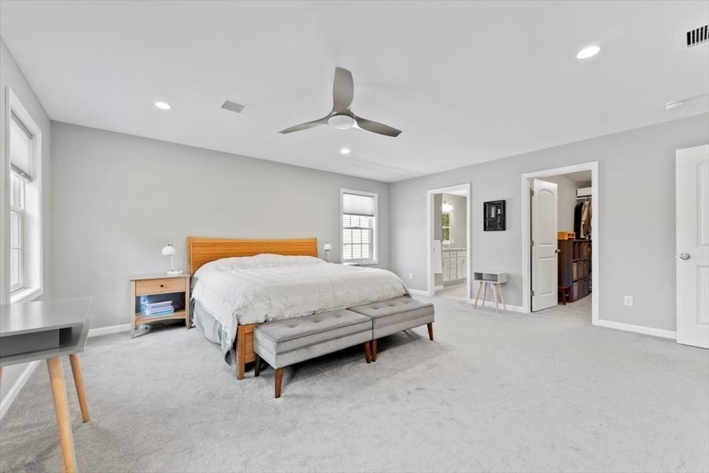145 Barrington Drive Springfield, MA 01129 - Photo 24 of 42 a spacious bedroom with a bed and a chandelier