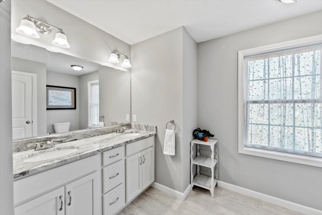 145 Barrington Drive Springfield, MA 01129 - Photo 31 of 42 a bathroom with a sink double vanity and a window