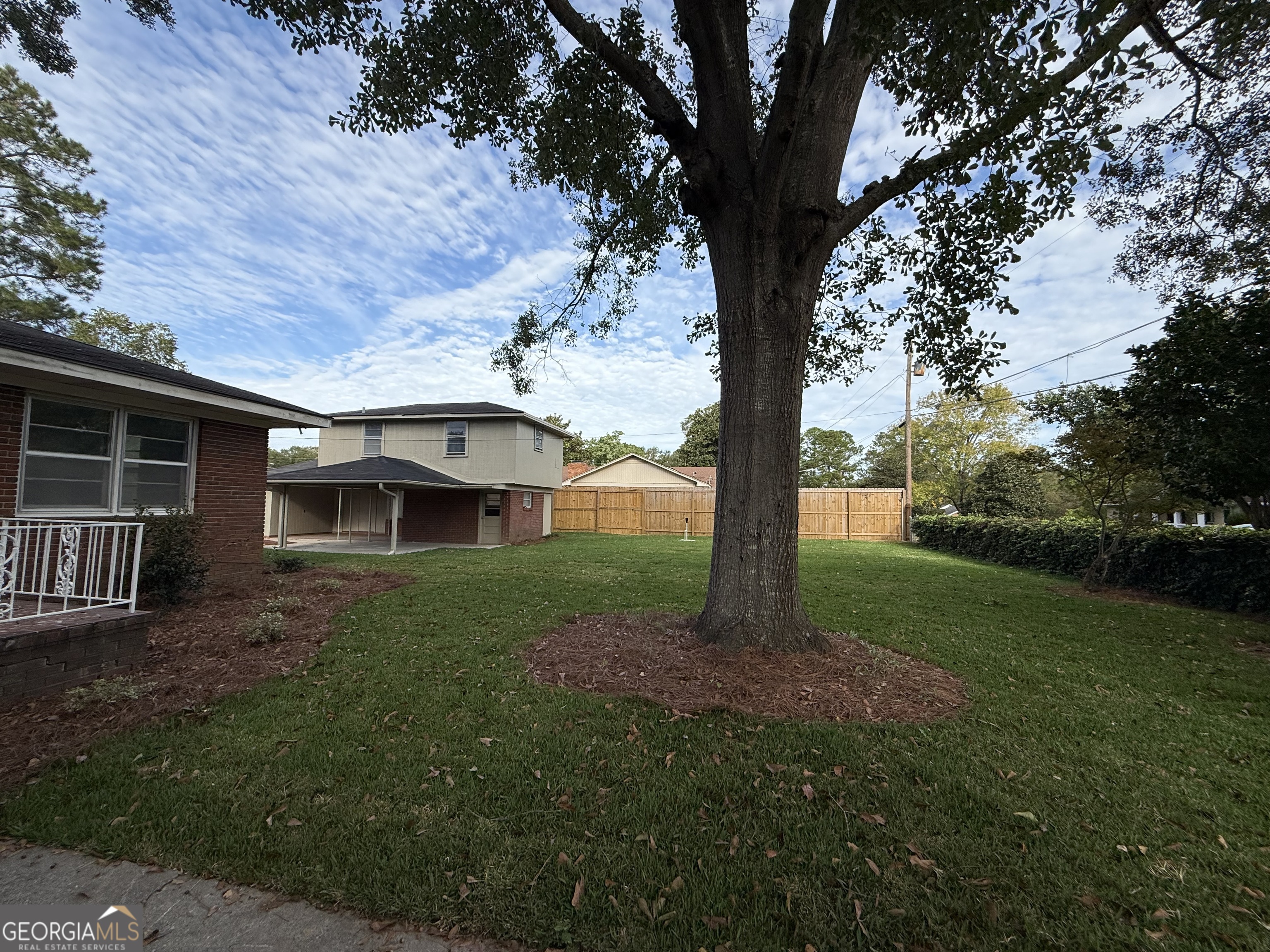 412 Roberson Street Dublin, GA 31021 - Photo 11 of 67 a view of a yard in front of a house with large trees