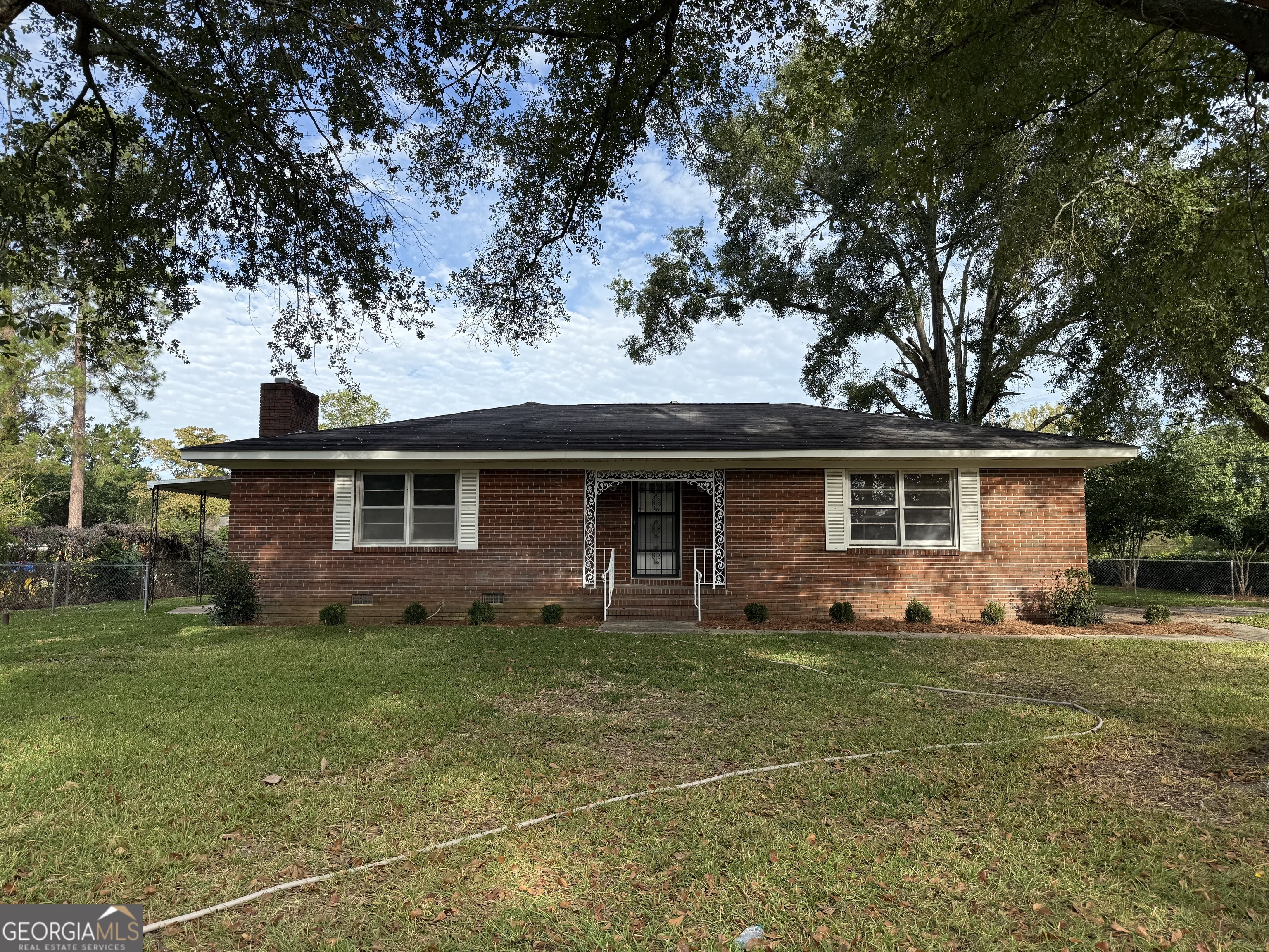 412 Roberson Street Dublin, GA 31021 - Photo 2 of 67 a front view of a house with yard and trees