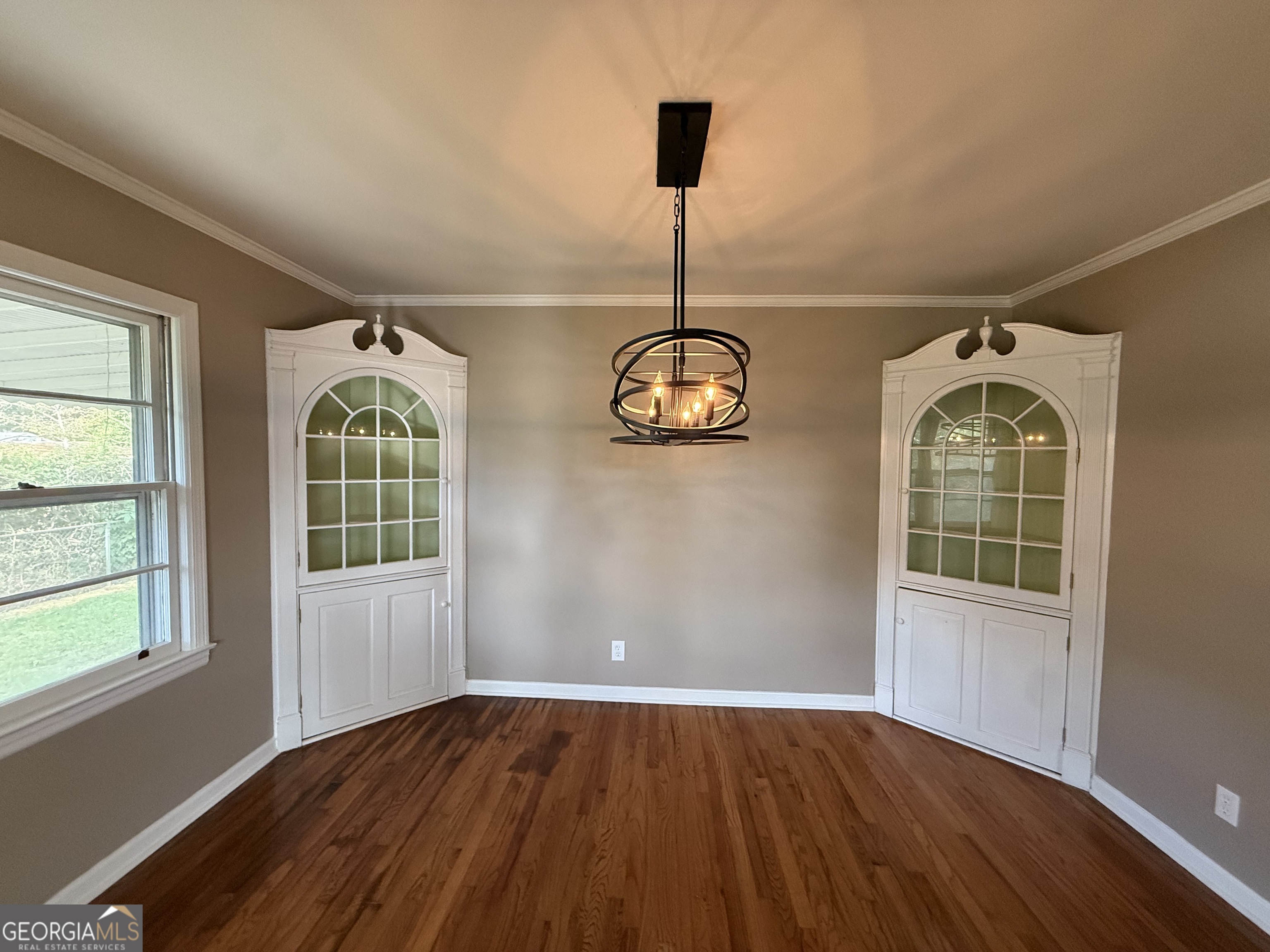 412 Roberson Street Dublin, GA 31021 - Photo 28 of 67 an empty room with wooden floor and windows
