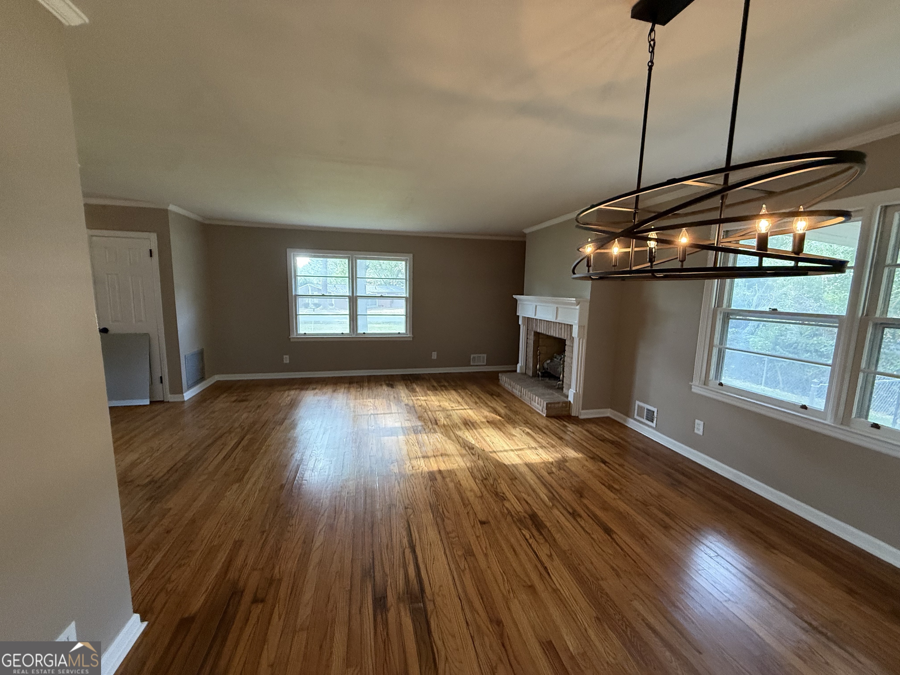 412 Roberson Street Dublin, GA 31021 - Photo 29 of 67 a view of empty room with wooden floor and fan