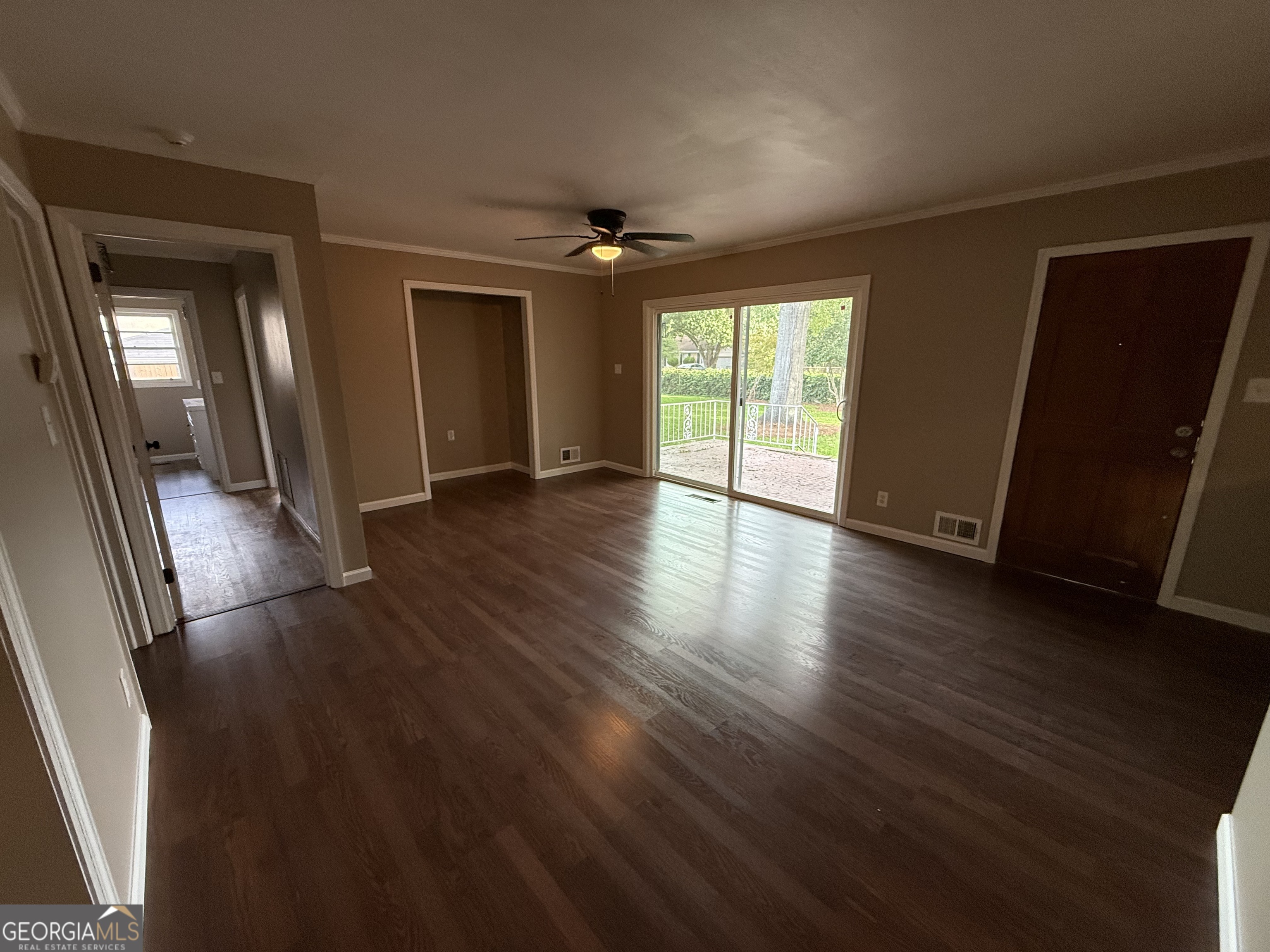 412 Roberson Street Dublin, GA 31021 - Photo 34 of 67 an empty room with wooden floor and windows