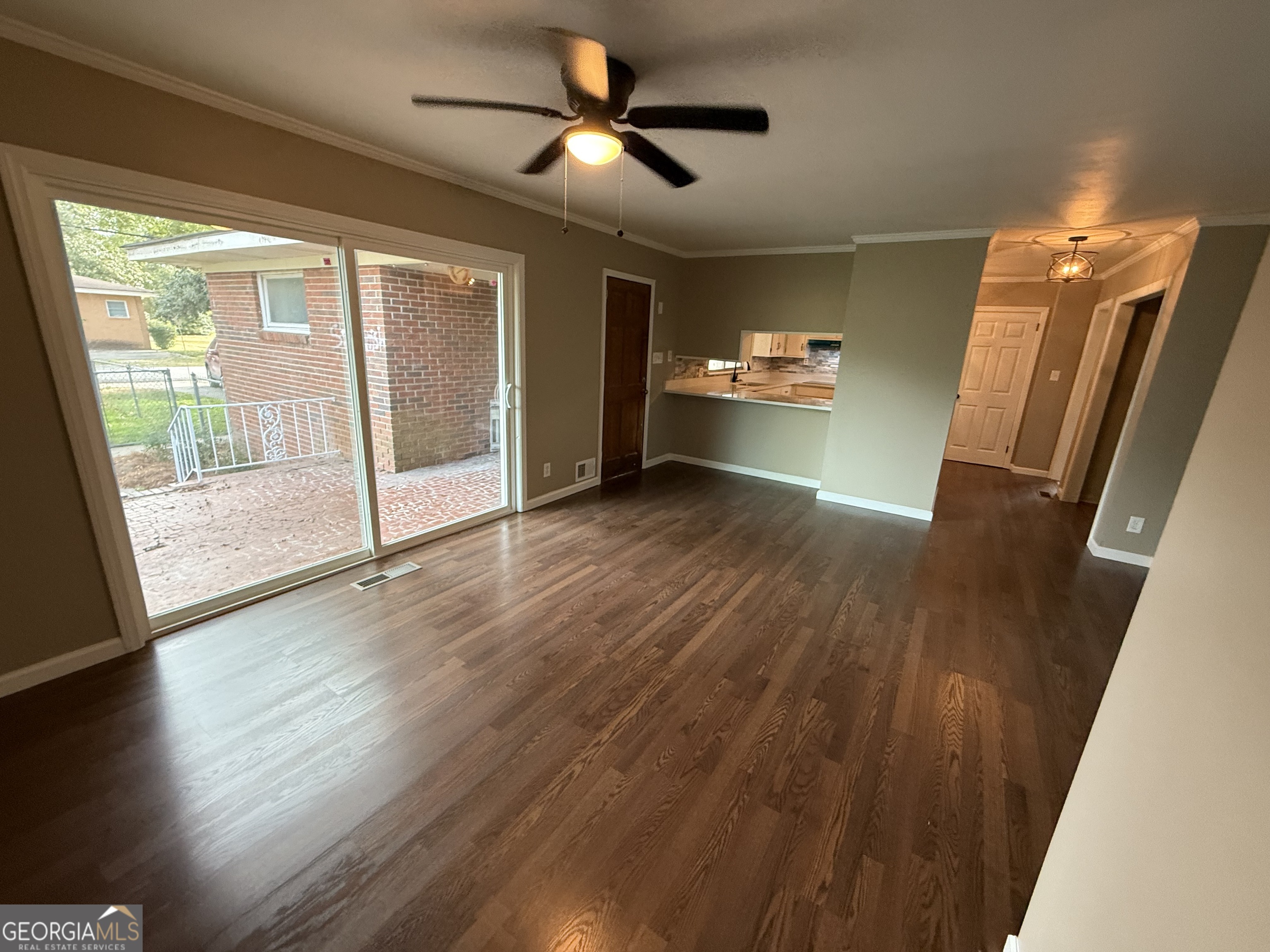 412 Roberson Street Dublin, GA 31021 - Photo 35 of 67 a view of empty room with wooden floor and fan