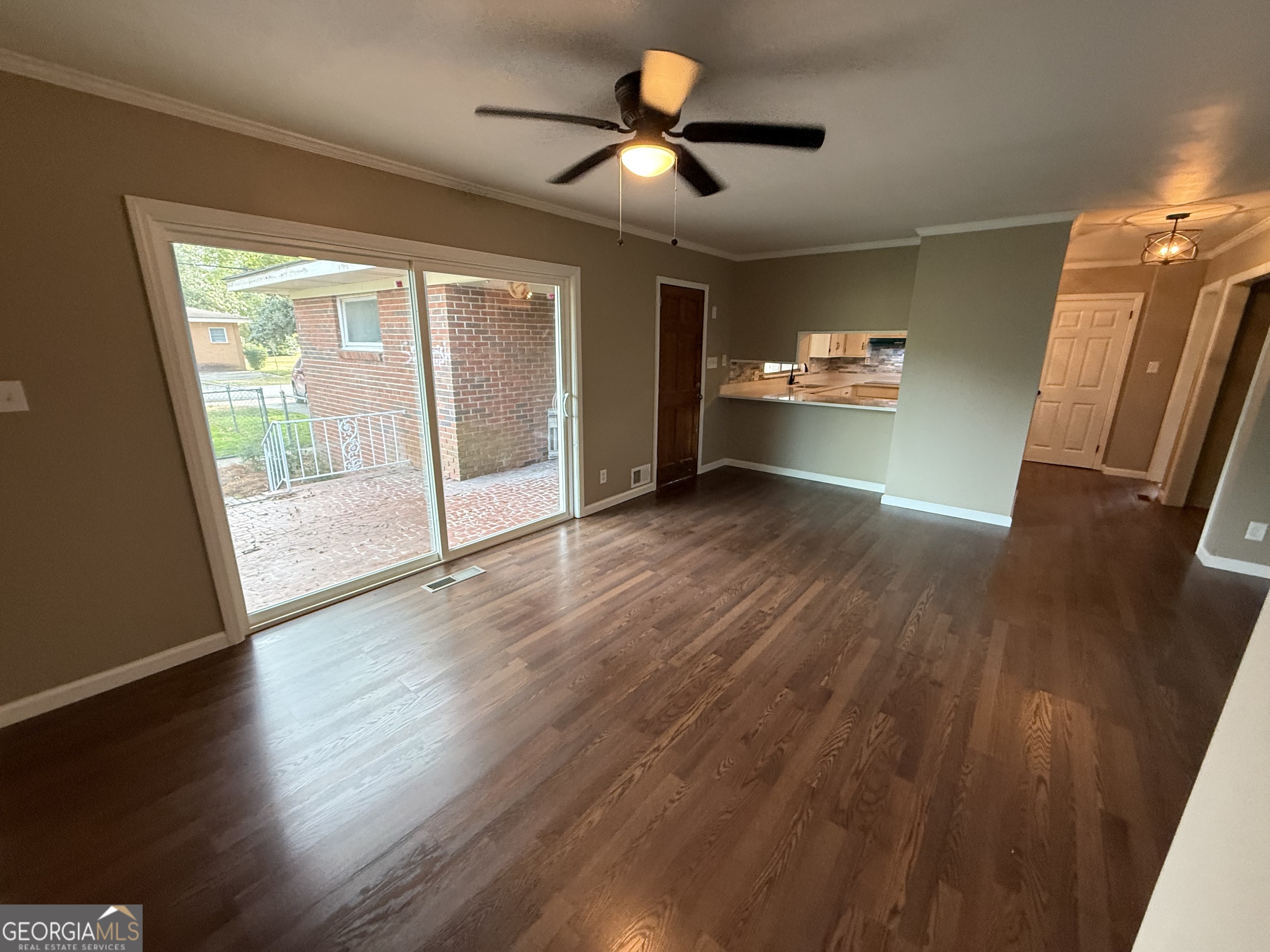 412 Roberson Street Dublin, GA 31021 - Photo 36 of 67 a view of an empty room with a window and wooden floor