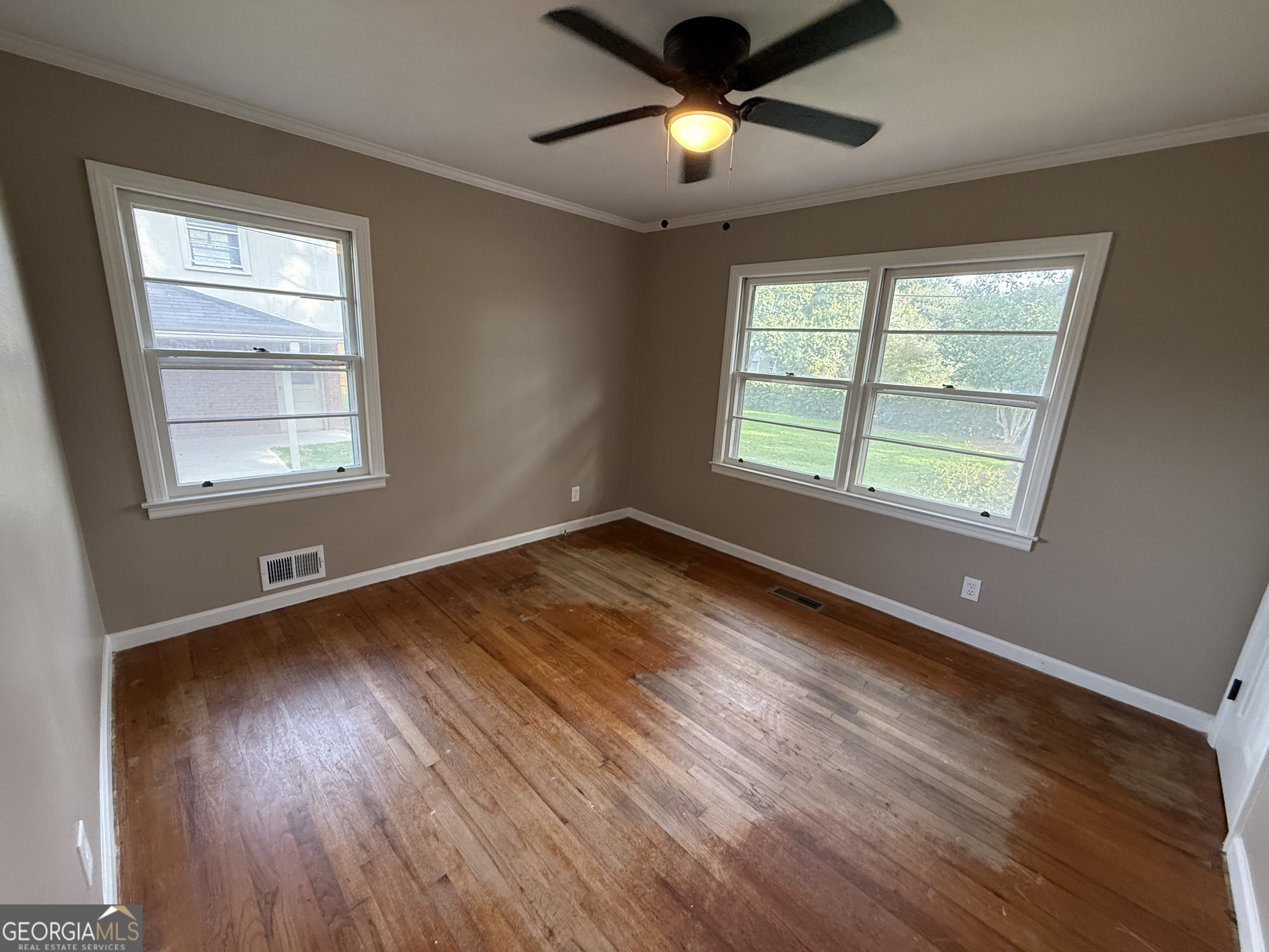 412 Roberson Street Dublin, GA 31021 - Photo 46 of 67 a view of an empty room with wooden floor and a window