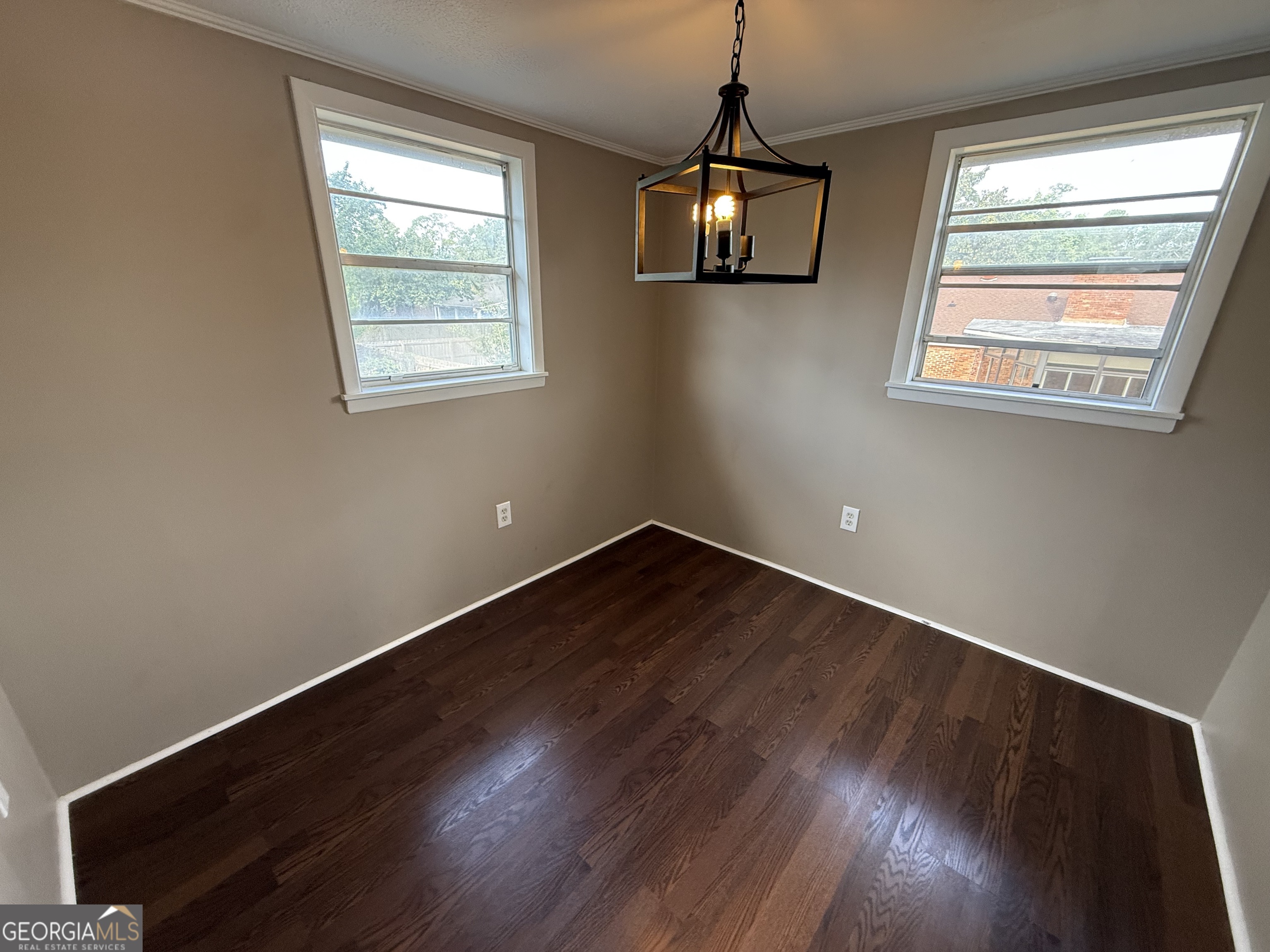 412 Roberson Street Dublin, GA 31021 - Photo 65 of 67 a view of an empty room with wooden floor and a window