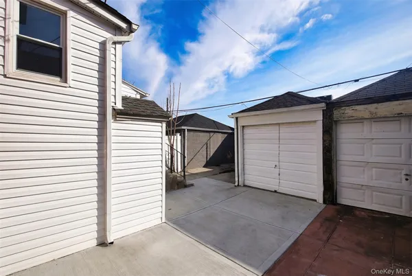 a view of a house with garage and furniture