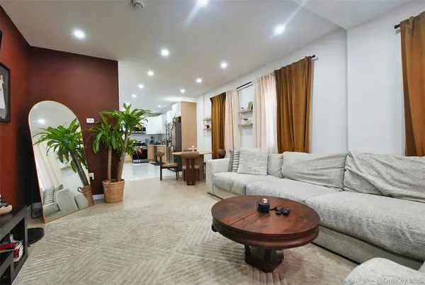 a living room with furniture and a potted plant