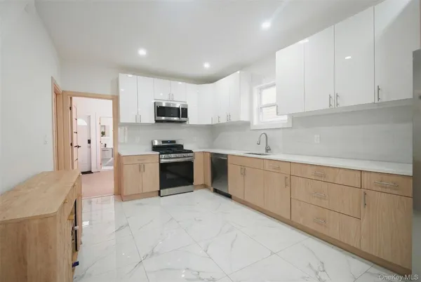 a kitchen with stainless steel appliances granite countertop a sink and cabinets