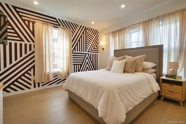 a bed sitting in a bedroom next to a window