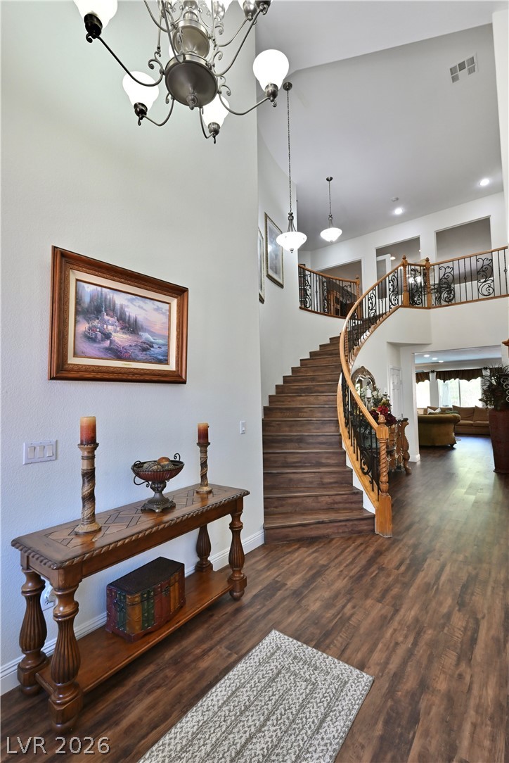 2729 Kildrummie Street Henderson, NV 89044 - Photo 35 of 42 A grand entryway features a sweeping staircase and rich wood flooring, inviting exploration of this generous interior.