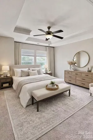 a bedroom with a bed a couch and window