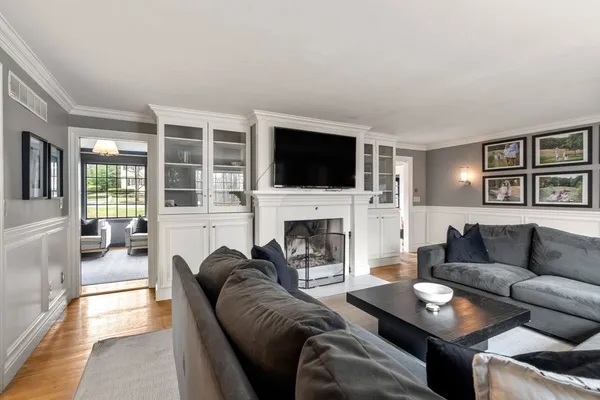 a living room with furniture a fireplace and a flat screen tv