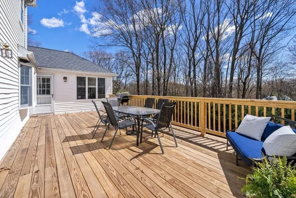 a view of a patio with a table chairs and wooden floor