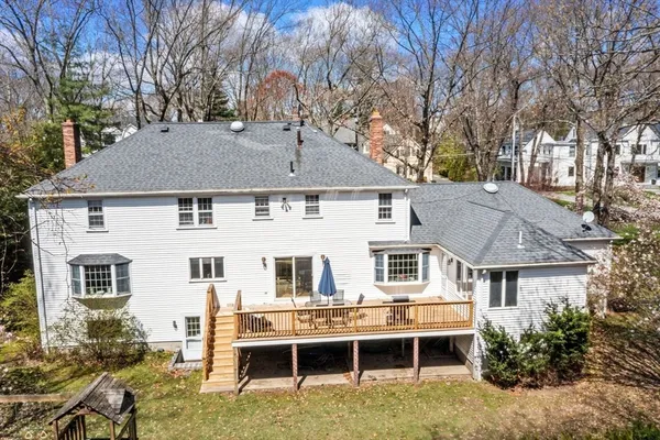 a aerial view of a house with a yard and potted plants