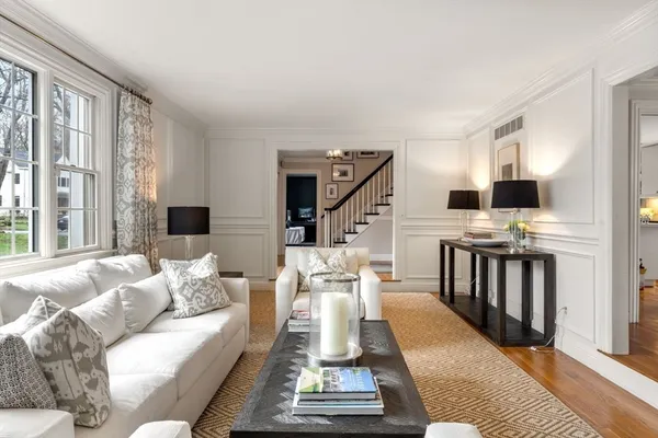 a living room with furniture fireplace and a table