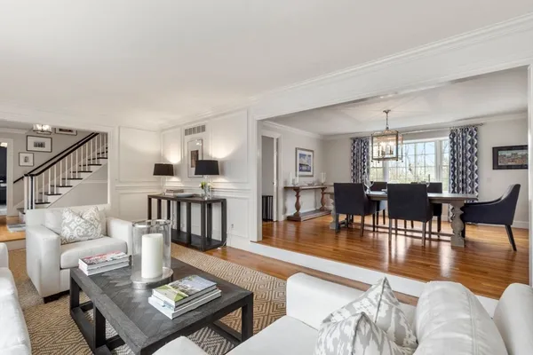 a living room with furniture and a table with wooden floor