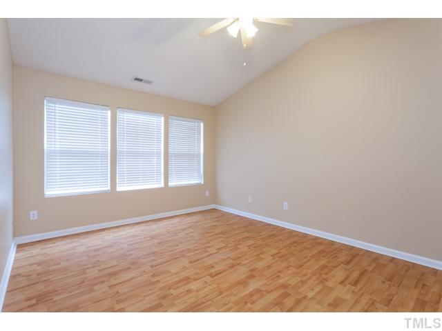 212 Purple Leaf Road Fuquay-Varina, NC 27526 - Photo 16 of 21 a view of an empty room with wooden floor and a window