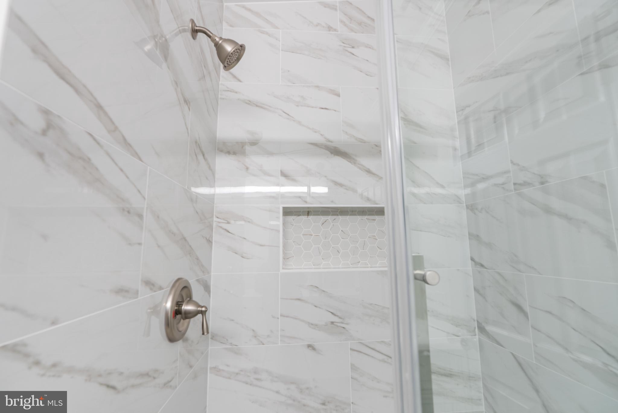 6430 Fourteenth Street Alexandria, VA 22307 - Photo 13 of 55 Elegant marble shower with modern fixtures.