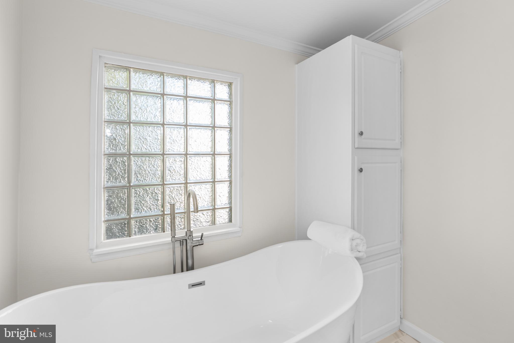 6430 Fourteenth Street Alexandria, VA 22307 - Photo 15 of 55 Serene bathroom with elegant tub and light.
