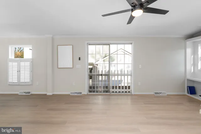 wooden floor in an empty room with a window