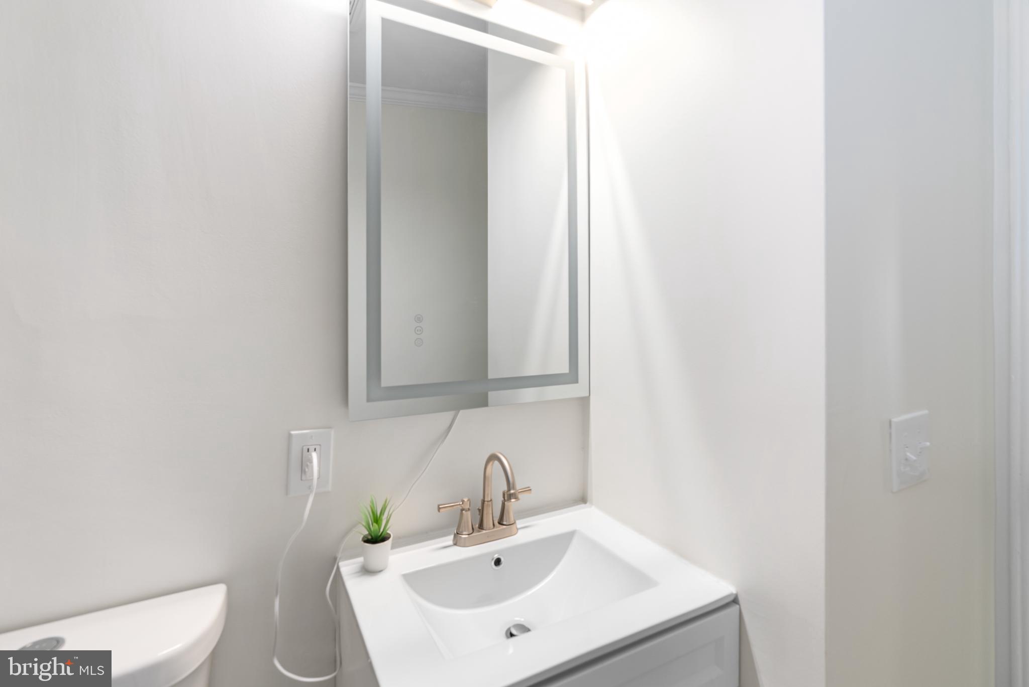 6430 Fourteenth Street Alexandria, VA 22307 - Photo 39 of 55 Sleek modern bathroom with elegant fixtures.