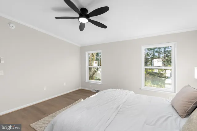 a bedroom with a large bed window and a window