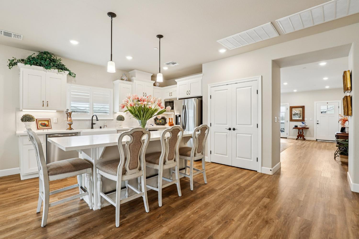 1124 North Palmer Road Galt, CA 95632 - Photo 12 of 41 a view of a dining room and livingroom with furniture wooden floor a chandelier