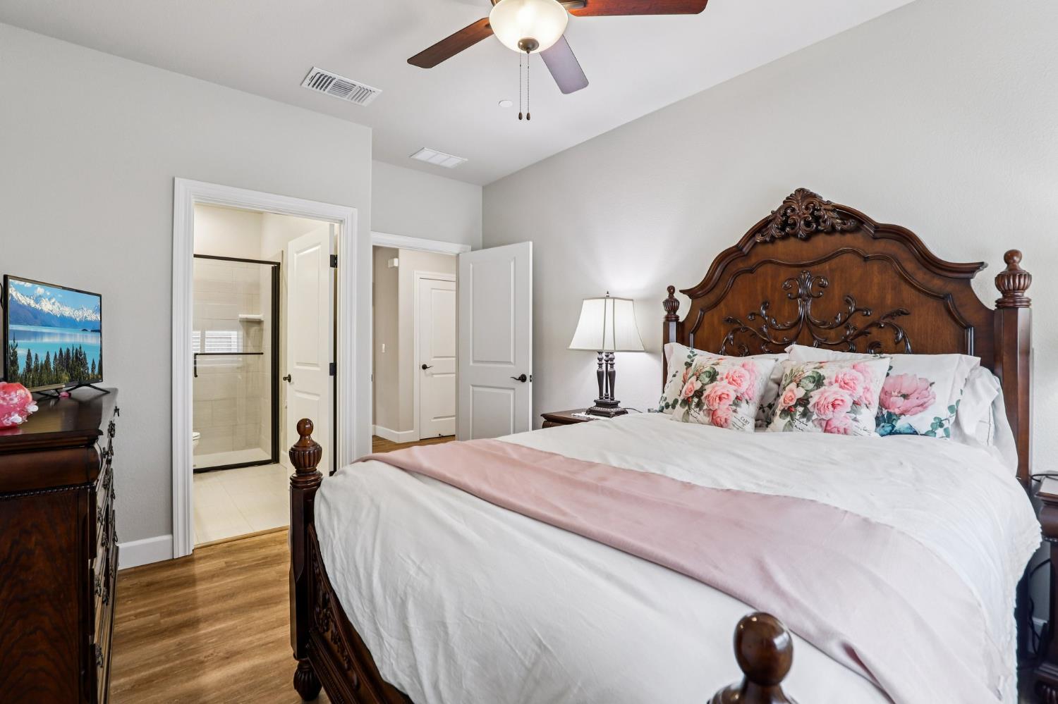 1124 North Palmer Road Galt, CA 95632 - Photo 20 of 41 a bedroom with a bed and a chandelier