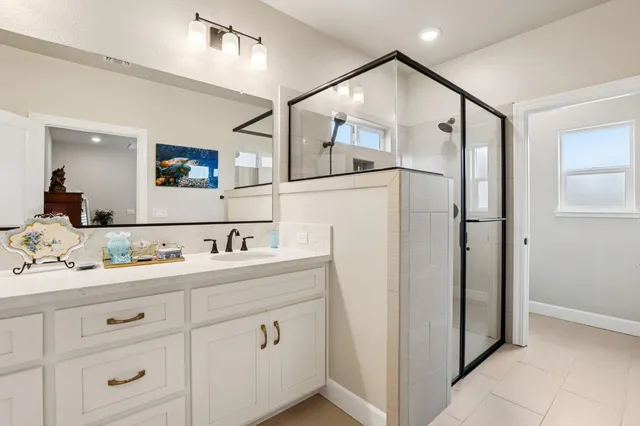 a bathroom with a double vanity sink and mirror