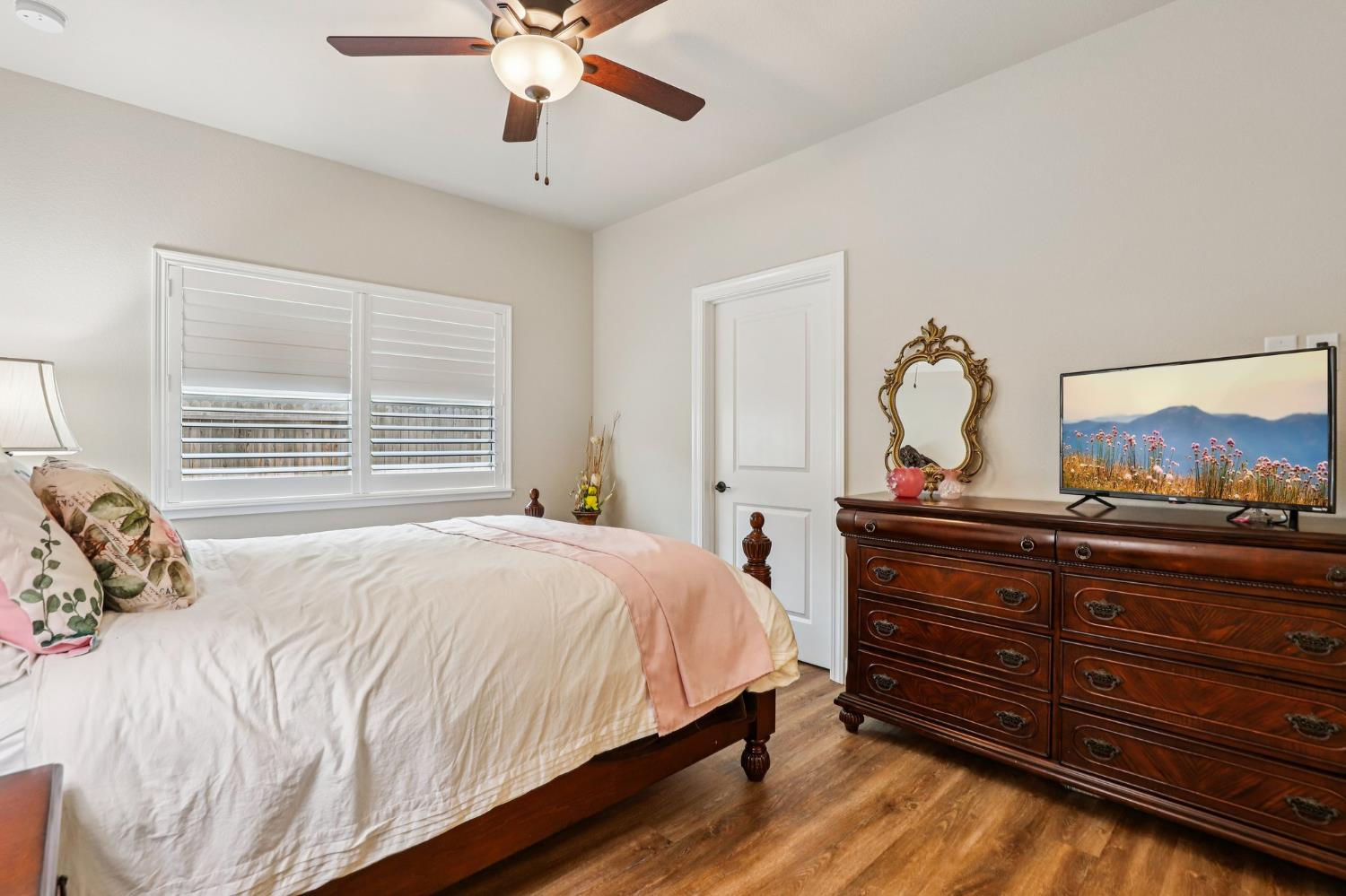 1124 North Palmer Road Galt, CA 95632 - Photo 26 of 41 a bedroom with a bed and wooden floor